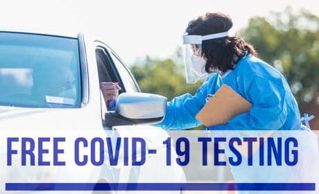 nurse performing COVID test to person in their car