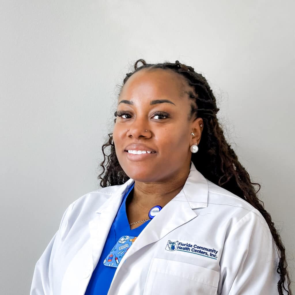 Headshot of Kadiann Reid, Infusion Nurse, smiling in a white FCHC lab coat.