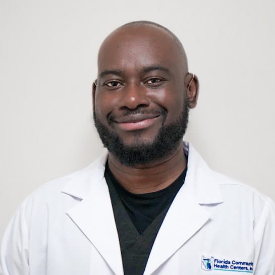 Elie Joseph, RDH, smiling in a white FCHC lab coat.