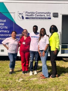 FCHC staff from Stuart and Outreach department pose for a quick photo at Fit Fest in front of their mobile unit van.