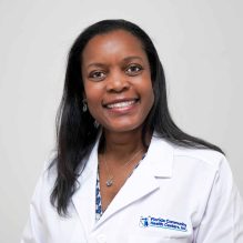 Headshot of Aryanna F. Lee, M.D., FAAP smiling in a white FCHC lab coat.