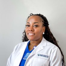 Headshot of Kadiann Reid, Infusion Nurse, smiling in a white FCHC lab coat.