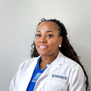 Headshot of Kadiann Reid, Infusion Nurse, smiling in a white FCHC lab coat.