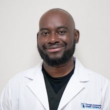 Elie Joseph, RDH, smiling in a white FCHC lab coat.